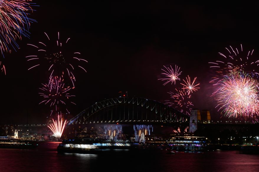 Fireworks burst over the Sydney Harbour Bridge as New Year's celebrations begin in Sydney, Wednesday, Dec. 31, 2025. (AP Photo/Rick Rycroft)