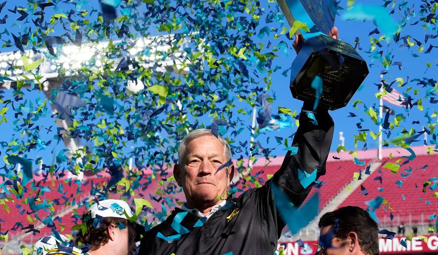 Iowa head coach Kirk Ferentz holds up the trophy after winning the ReliaQuest Bowl NCAA college football game against Vanderbilt Wednesday, Dec. 31, 2025, in Tampa, Fla. (AP Photo/Chris O'Meara)