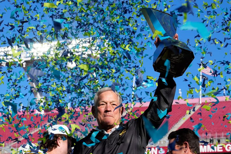 Iowa head coach Kirk Ferentz holds up the trophy after winning the ReliaQuest Bowl NCAA college football game against Vanderbilt Wednesday, Dec. 31, 2025, in Tampa, Fla. (AP Photo/Chris O'Meara)