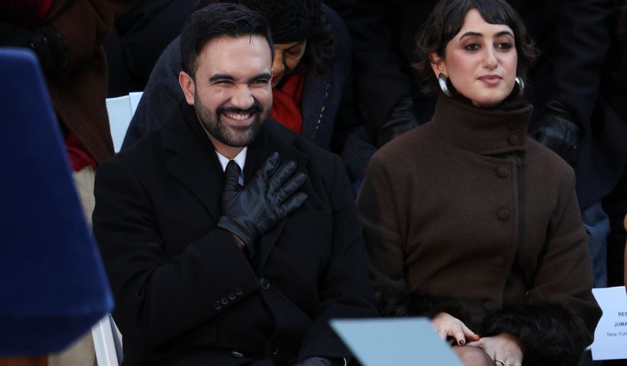 Mayor Zohran Mamdani reacts after arriving for his swearing-in ceremony as Rama Duwaji looks on, Thursday, Jan. 1, 2026, in New York. (AP Photo/Heather Khalifa)