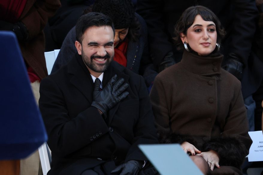 Mayor Zohran Mamdani reacts after arriving for his swearing-in ceremony as Rama Duwaji looks on, Thursday, Jan. 1, 2026, in New York. (AP Photo/Heather Khalifa)