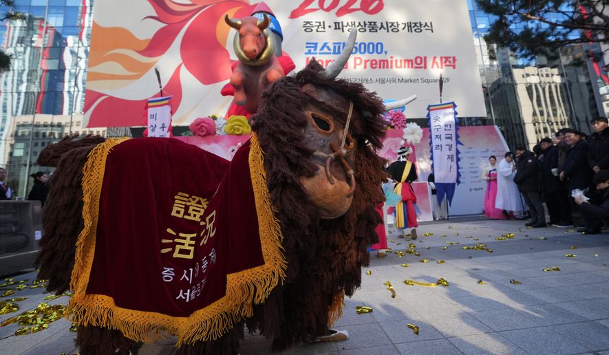 Dancers in a bull-shaped costume perform to celebrate the opening for the 2026 trading year outside of the Korea Exchange in Seoul, South Korea, Friday, Jan. 2, 2026. (AP Photo/Lee Jin-man)