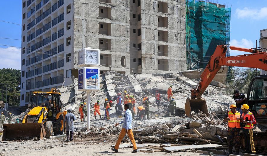 A rescue team works at the scene of a collapsed building in Nairobi, Kenya, Friday, Jan. 2, 2026. (AP Photo/Andrew Kasuku)