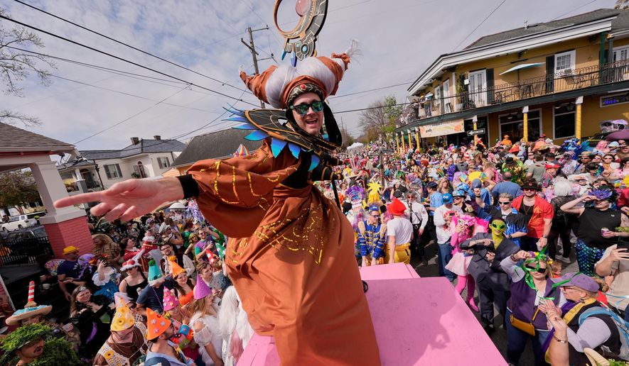 FILE- People gather for the start of the Society of Saint Anne's parade on Mardi Gras Day, March 4, 2025 in New Orleans. (AP Photo/Gerald Herbert, File)