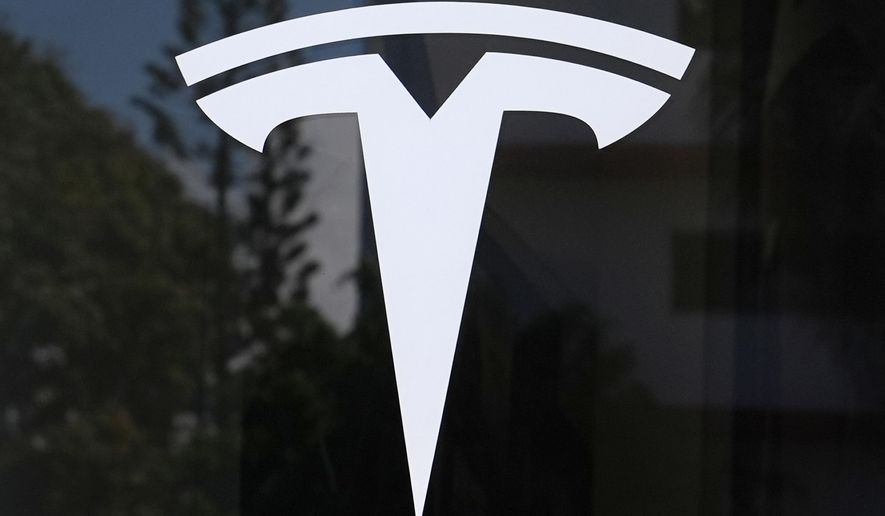 The Tesla logo is displayed at a Tesla dealership Thursday, Mar. 13, 2025, in Miami. (AP Photo/Lynne Sladky, File)