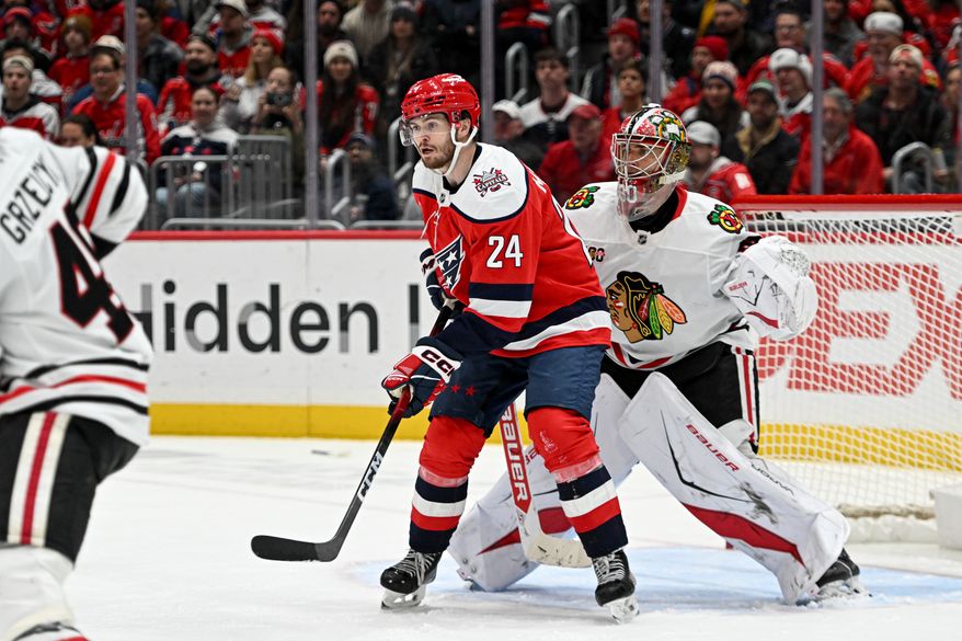 Washington Capitals center Connor McMichael (24) in front of the net screening Chicago Blackhawks goalie Spencer Knight (30) during the third period of an NHL game at Capital One Arena in Washington D.C., January 3, 2026. (Photo for the Washington Times)