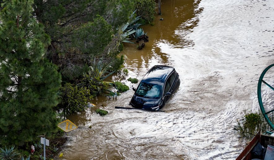 A car flooded by the "King Tides", occurring when the sun, moon and Earth align, causing a stronger gravitational pull Saturday, Jan. 3, 2026, near Corte Madera in Marin County, Calif. (AP Photo/Ethan Swope)