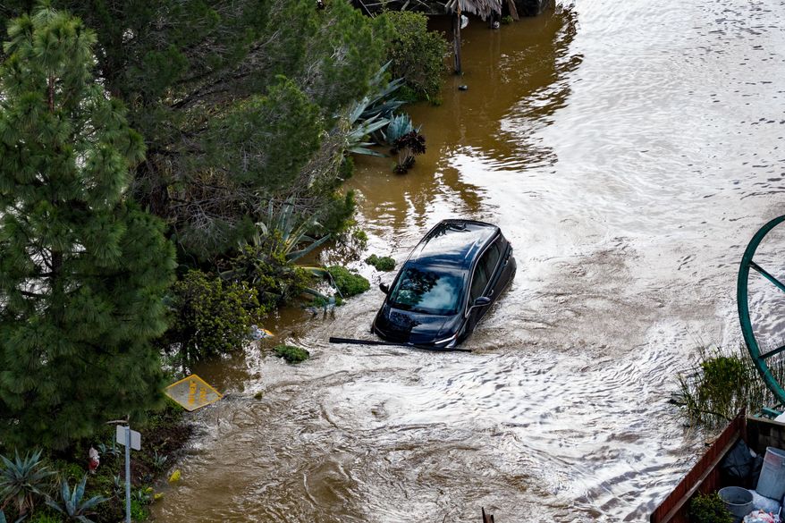 A car flooded by the "King Tides", occurring when the sun, moon and Earth align, causing a stronger gravitational pull Saturday, Jan. 3, 2026, near Corte Madera in Marin County, Calif. (AP Photo/Ethan Swope)