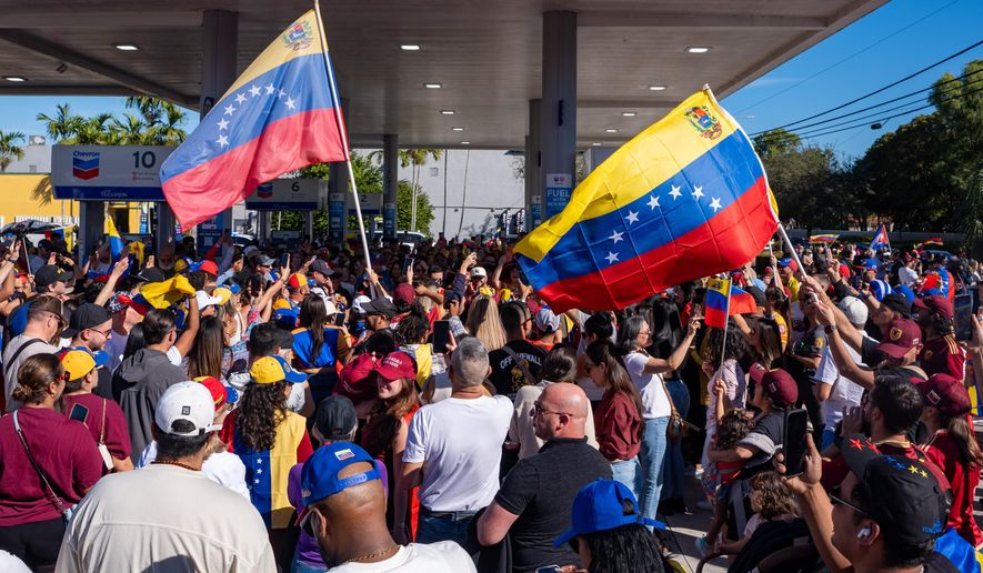 People celebrate after President Donald Trump announced Venezuelan President Nicolás Maduro had been captured and flown out of the country, in Doral, Fla., Saturday, Jan. 3, 2026. (AP Photo/Jen Golbeck)