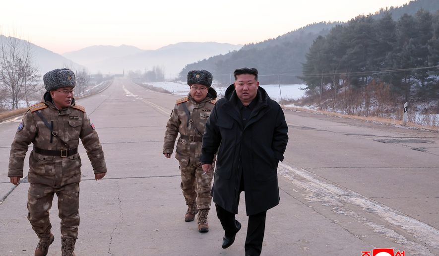In this photo provided by the North Korean government, leader Kim Jong Un walks on a road as he inspects test-flights of hypersonic missiles, in Pyongyang, North Korea, Sunday, Jan. 4, 2026. Independent journalists were not given access to cover the event depicted in this image distributed by the North Korean government. The content of this image is as provided and cannot be independently verified. Korean language watermark on image as provided by source reads: "KCNA" which is the abbreviation for Korean Central News Agency. (Korean Central News Agency/Korea News Service via AP)