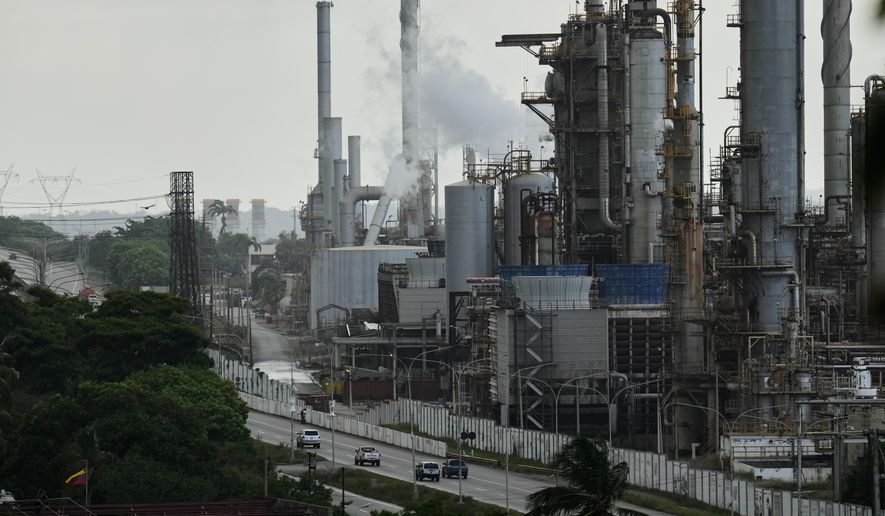 Vehicles drive past the El Palito refinery in Puerto Cabello, Venezuela, Sunday, Dec. 21, 2025. (AP Photo/Matias Delacroix, file)