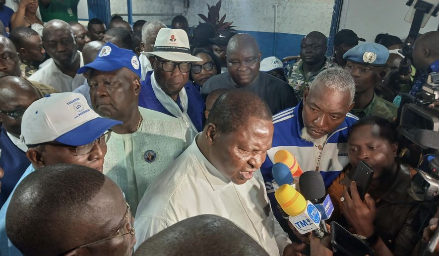 Central African Republic President Faustin Archange Touadéra, bottom center, speaks to the media after being declared the winner of the presidential election in Bangui, Central African Republic, Monday, Jan. 5, 2026. (AP Photo/Jean-Fernand Koena)