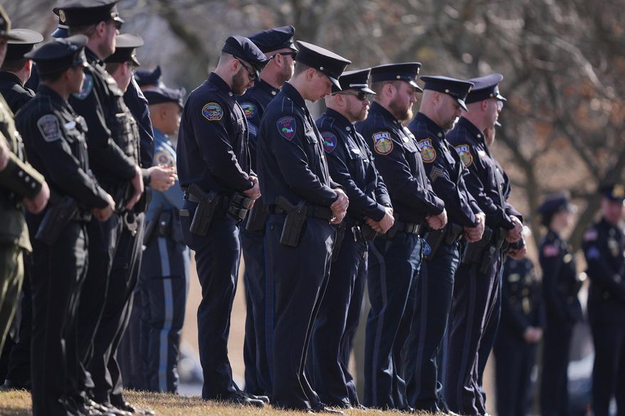 Officers wait for slain West York Borough Police Officer Andrew Duarte's funeral procession from Living Word Community Church, in Red Lion, Pa., Feb. 28, 2025. (AP Photo/Matt Rourke, File)