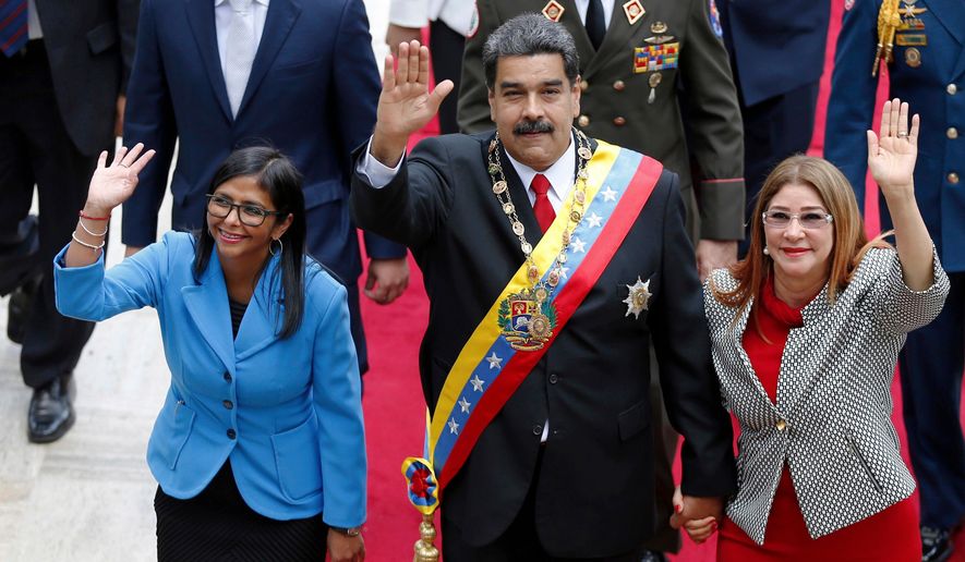 Venezuela's President Nicolas Maduro, then Constituent National Assembly President Delcy Rodriguez, left, and first lady Cilia Flores, wave as they arrive to the National Assembly, in Caracas, Venezuela, May 24, 2018. (AP Photo/Ariana Cubillos, File)