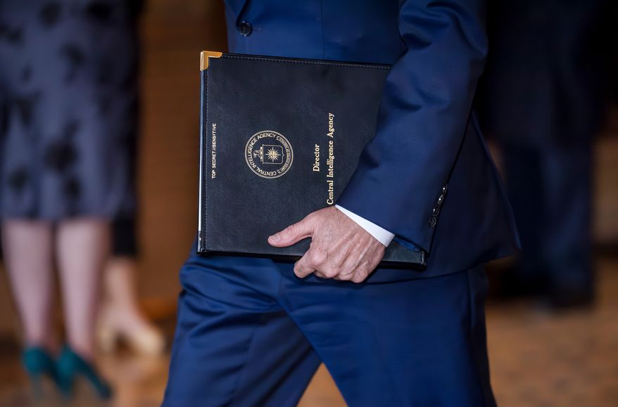 CIA Director John Ratcliffe carries a folio marked "Top Secret" as he arrives for a classified briefing with senators on the situation in Venezuela, at the Capitol in Washington, Wednesday, Jan. 7, 2026. (AP Photo/J. Scott Applewhite)