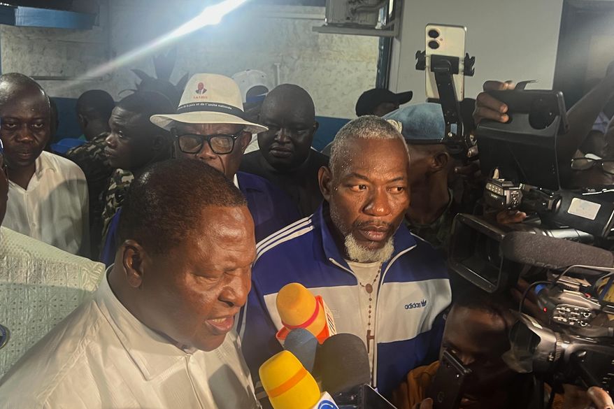 Central African Republic President Faustin Archange Touadéra, bottom left, speaks to the media after being declared the winner of the presidential election in Bangui, Central African Republic, Monday, Jan. 5, 2026. (AP Photo/Jean-Fernand Koena)