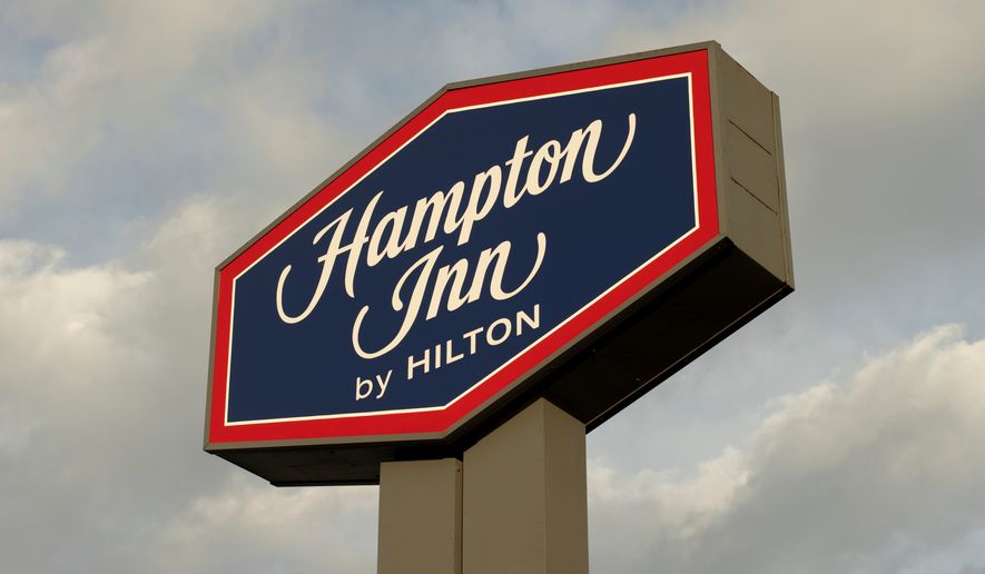 Closeup of the Hampton Inn by Hilton sign outside a Hampton Inn in Clackamas, Oregon, along the OR-205 state highway. File photo credit: Tada Images via Shutterstock.