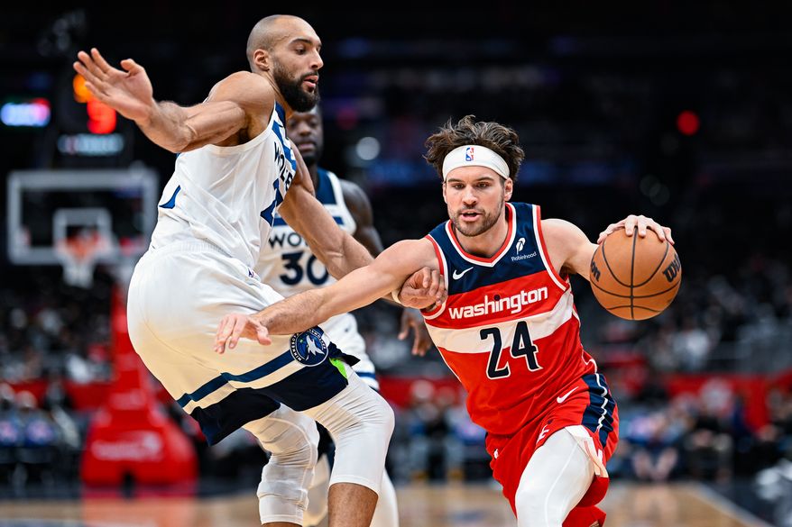 Washington Wizards forward Corey Kispert (24) dribbles through defensive pressure by Minnesota Timberwolves center Rudy Gobert (27) at Capital One Arena, Washington, D.C., January 4, 2026. (Photo by Brian Murphy for the Washington Times)