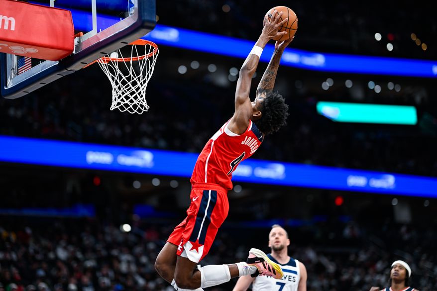 Washington Wizards guard AJ Johnson (4) elevates for an alley-oop attempt after a lob pass from guard Tre Johnson (12) at Capital One Arena, Washington, D.C., January 4, 2026. (Photo by Brian Murphy for the Washington Times)