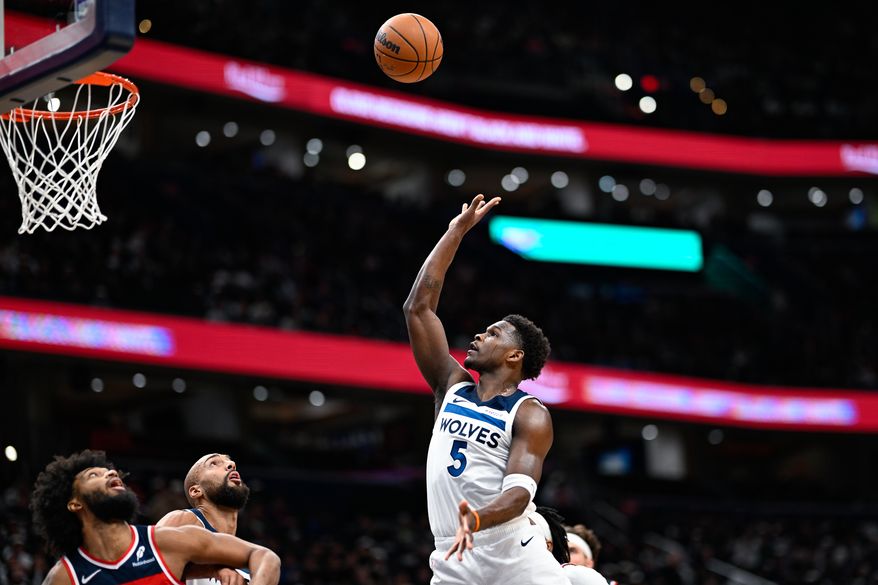 Minnesota Timberwolves guard Anthony Edwards (5) floats a shot over center Rudy Gobert (27) and Washington Wizards center Marvin Bagley III (35) at Capital One Arena, Washington, D.C., January 4, 2026. (Photo by Brian Murphy for the Washington Times)