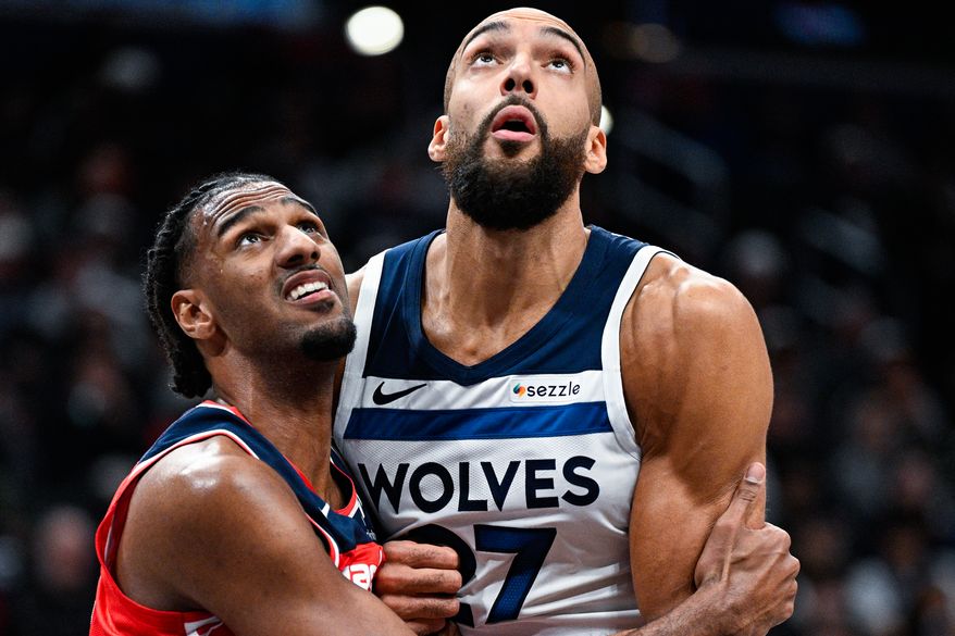 Washington Wizards forward Alex Sarr (20) and Minnesota Timberwolves center Rudy Gobert (27) wrestle for positioning in the paint at Capital One Arena, Washington, D.C., January 4, 2026. (Photo by Brian Murphy for the Washington Times)