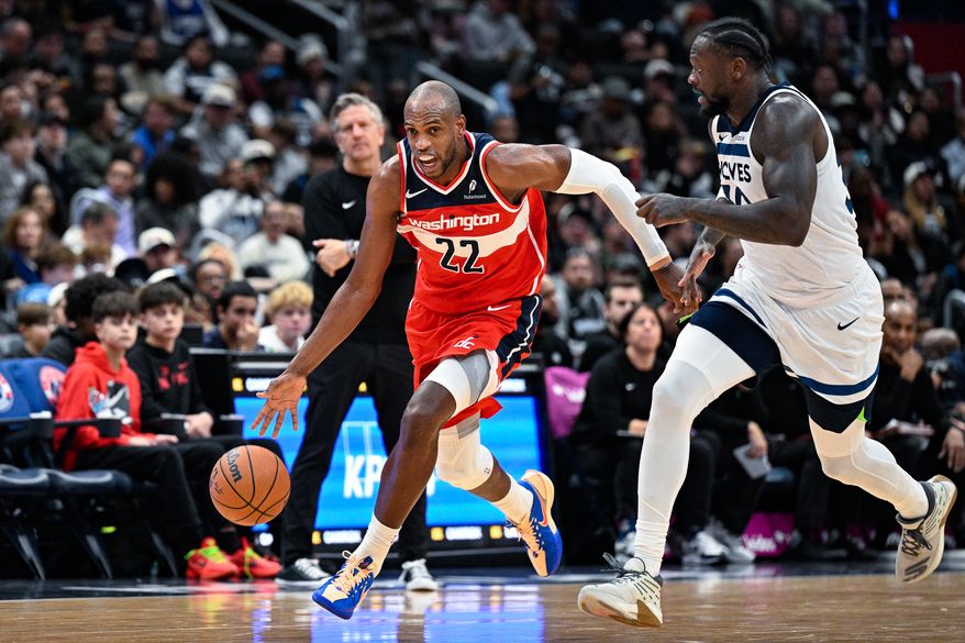 Washington Wizards forward Khris Middleton (22) accelerates past Minnesota Timberwolves forward Julius Randle (30) to bring the ball up the court at Capital One Arena, Washington, D.C., January 4, 2026. (Photo by Brian Murphy for the Washington Times)