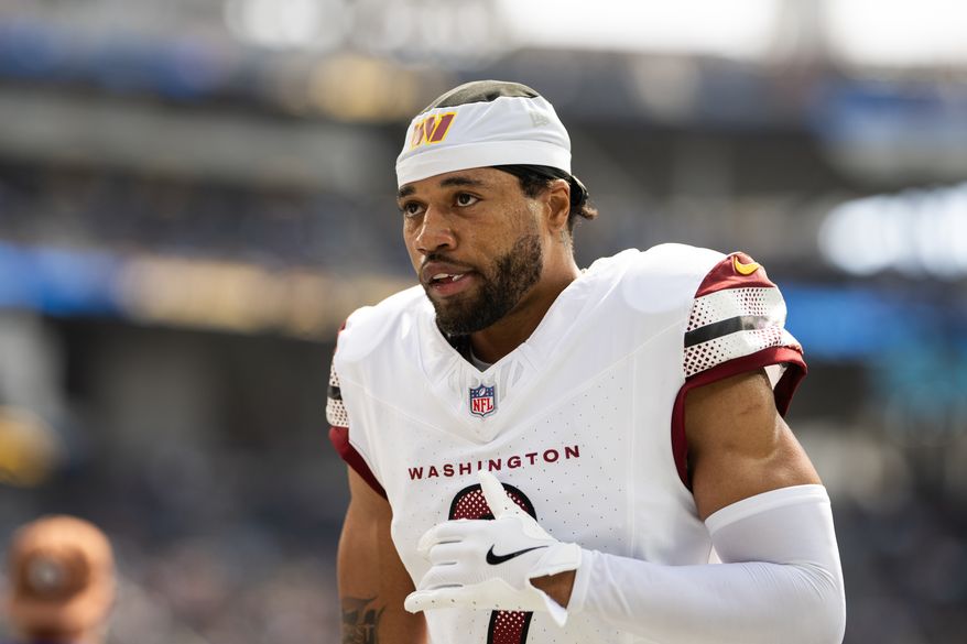 Washington Commanders cornerback Marshon Lattimore (2) walks back to the locker room before an NFL football game against the Los Angeles Chargers, Sunday, Oct. 5, 2025, in Inglewood, Calif. (AP Photo/Kyusung Gong)