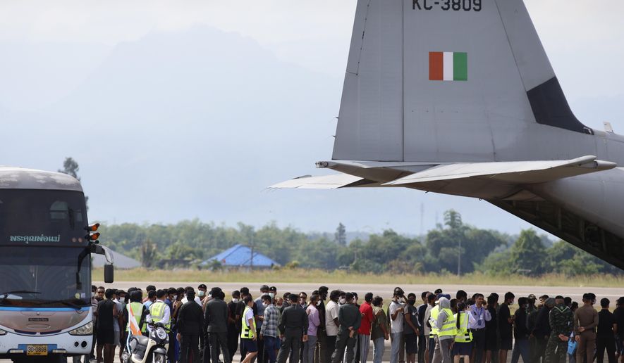 FILE -India nationals, believed to have worked at scam center in Myanmar, board a plane at Thailand's Mae Sot International Airport in Tak, before being sent back to India Nov. 6, 2025. (AP Photo/Sarot Meksophawannakul, File)