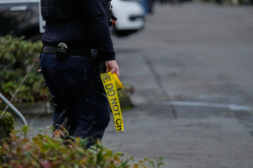 Law enforcement officials work the scene following reports that federal immigration officers shot and wounded people in Portland, Ore., Thursday, Jan. 8, 2026. (AP Photo/Jenny Kane)