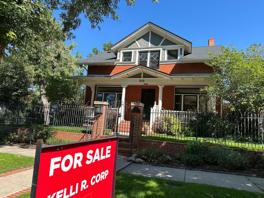 A for sale sign stands outside a home on the market in the Alamo Placita neighborhood Tuesday, Aug. 27, 2024, in central Denver. (AP Photo/David Zalubowski, File)