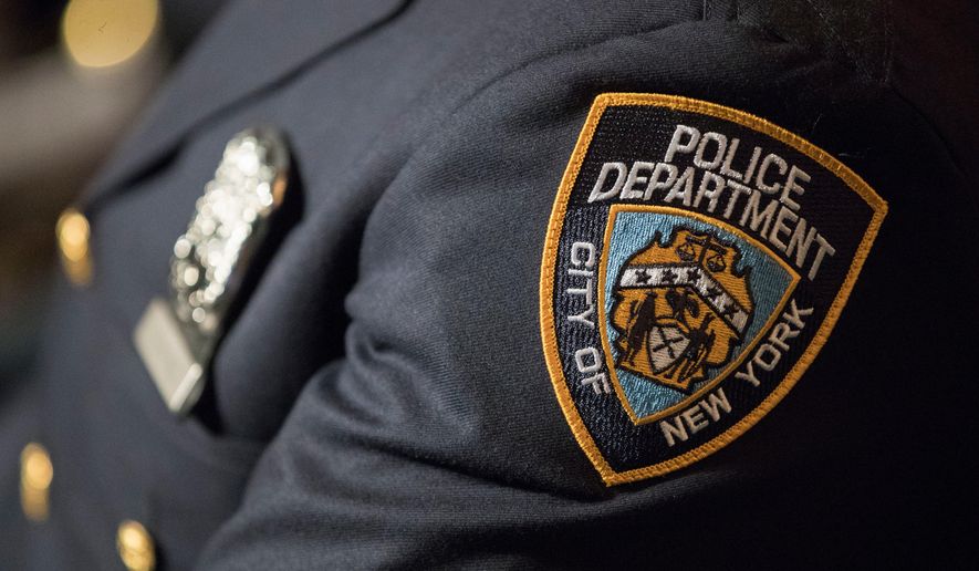 FILE- A detail including the badge and shield of one of the newest members of the New York City police is seen during his graduation ceremony, June 29, 2017, in New York. (AP Photo/Mary Altaffer, File)