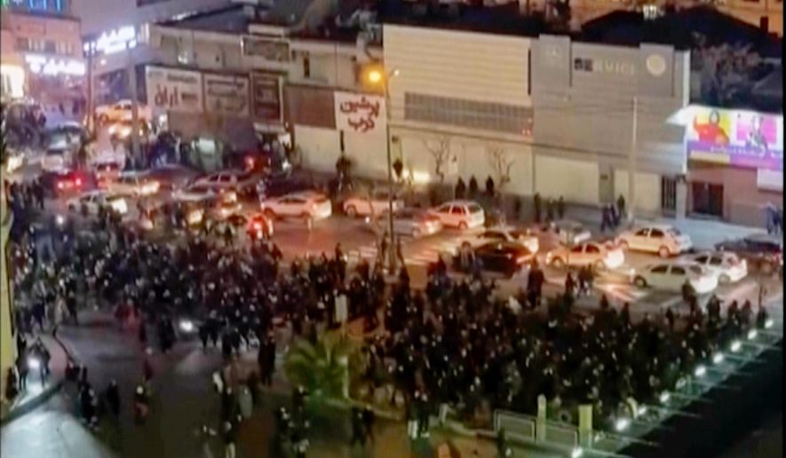 In this frame grab from video taken by an individual not employed by The Associated Press and obtained by the AP outside Iran shows people blocking an intersection during a protest in Tehran, Iran, Thursday Jan. 8, 2026. (UGC via AP)