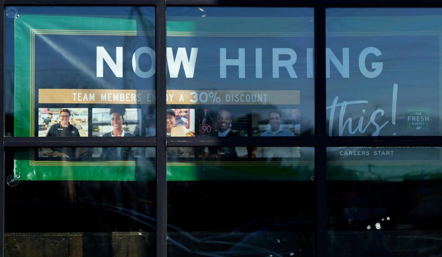 A hiring sign is displayed at a grocery store in Northbrook, Ill., Tuesday, Jan. 21, 2025. (AP Photo/Nam Y. Huh)