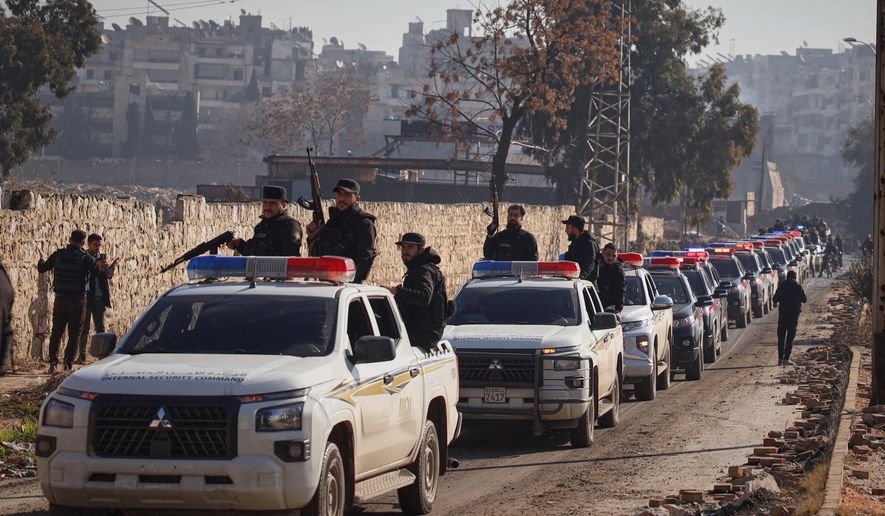 A Syrian police convoy gathers in the Sheikh Maqsoud neighborhood, where clashes between government forces and Kurdish fighters have been taking place in the northern city of Aleppo, Syria, Saturday, Jan. 10, 2026. (AP Photo/Omar Albam)