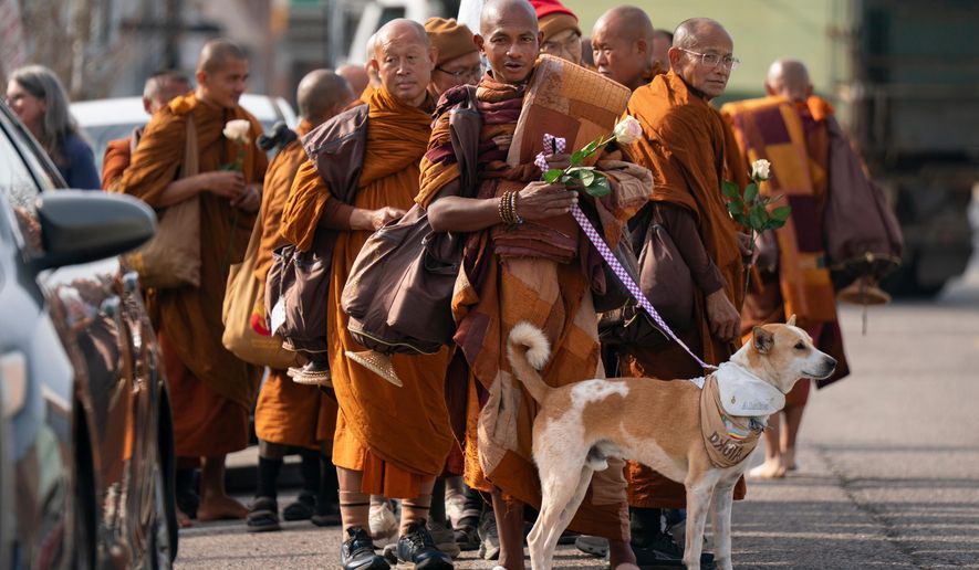 Buddhist monks who are participating in the, "Walk For Peace," are seen with their dog, Aloka, Thursday, Jan. 8, 2026, in Saluda, S.C. (AP Photo/Allison Joyce)