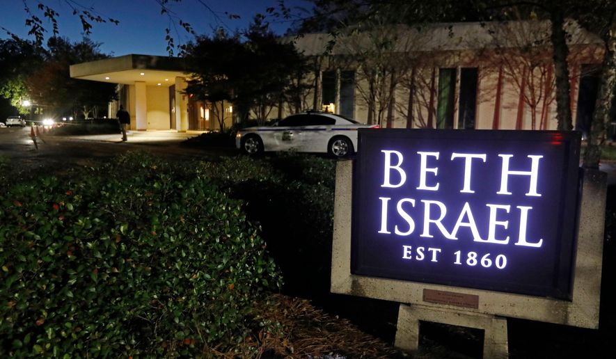 This Nov. 2, 2018 photo shows an armed Hinds County Sheriff's deputy outside of the Beth Israel Congregation synagogue in Jackson, Miss. (AP Photo/Rogelio V. Solis, file)