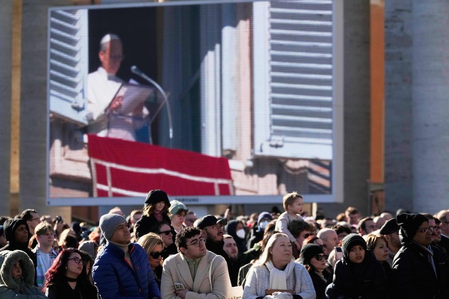 Faithful listen to Pope Leo XIV's Angelus noon prayer in St. Peter's Square at the Vatican, Sunday, Jan. 11, 2026. (AP Photo/Gregorio Borgia)