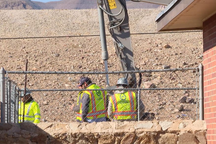 A still frame from video showed crews with El Paso Water working to restore services after a water main break on Sunday, Jan. 11, 2026, in El Paso, Texas. (KFOX News via AP)