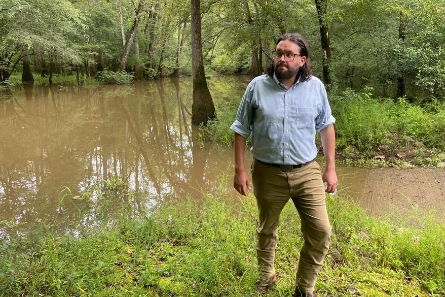FILE - Seth Clark, then mayor pro-tem of Macon, walks in the Bond Swamp National Wildlife Refuge in Round Oak, Ga., on Aug. 22, 2022. (AP Photo/Michael Warren, File)