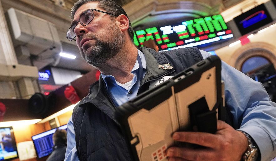 Trader Michael Capolino works on the floor of the New York Stock Exchange, Monday, Jan. 12, 2026. (AP Photo/Richard Drew)