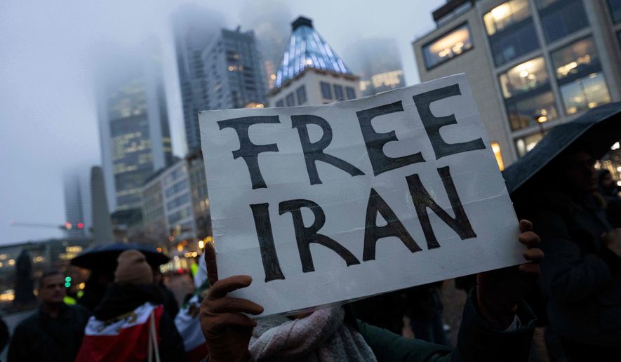 People attend a rally in Frankfurt, Germany, Monday, Jan. 12, 2026. (Boris Roessler/dpa via AP)