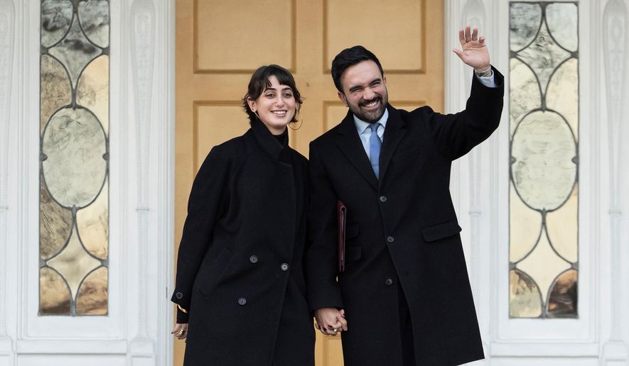New York Mayor Zohran Mamdani, right, and his wife Rama Duwaji wave at members of media after a news conference at Gracie Mansion, Monday, Jan. 12, 2026, in New York. (AP Photo/Yuki Iwamura)