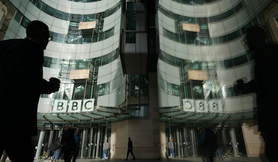 Pedestrian walks outside the BBC Headquarters in London, Wednesday, Nov. 12, 2025. (AP Photo/Kin Cheung, file)