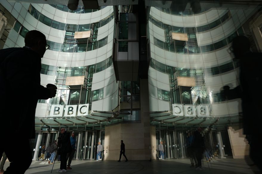 Pedestrian walks outside the BBC Headquarters in London, Wednesday, Nov. 12, 2025. (AP Photo/Kin Cheung, file)
