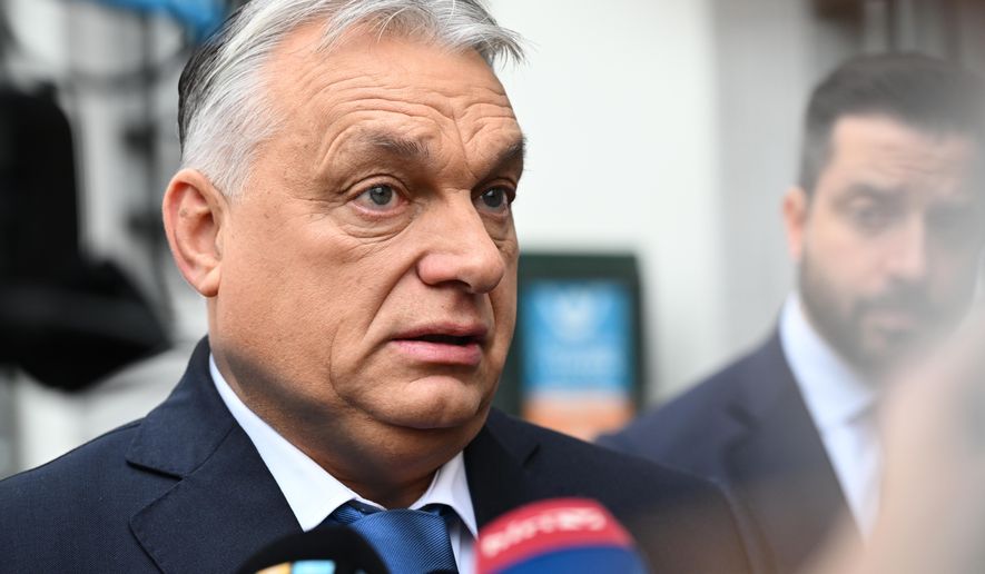 Hungary's Prime Minister Viktor Orban speaks with the media as he arrives for the Patriots for Europe group leaders meeting ahead of an EU leaders summit in Brussels, Wednesday, Dec. 17, 2025. (AP Photo/Harry Nakos)