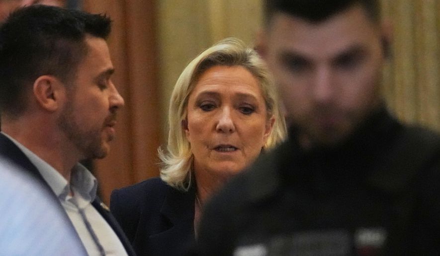 Far-right leader Marine Le Pen leaves for a break during her appeal trial after an embezzlement conviction, Tuesday, Jan. 13, 2026 in Paris. (AP Photo/Christophe Ena)