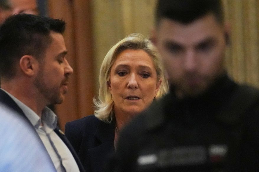 Far-right leader Marine Le Pen leaves for a break during her appeal trial after an embezzlement conviction, Tuesday, Jan. 13, 2026 in Paris. (AP Photo/Christophe Ena)