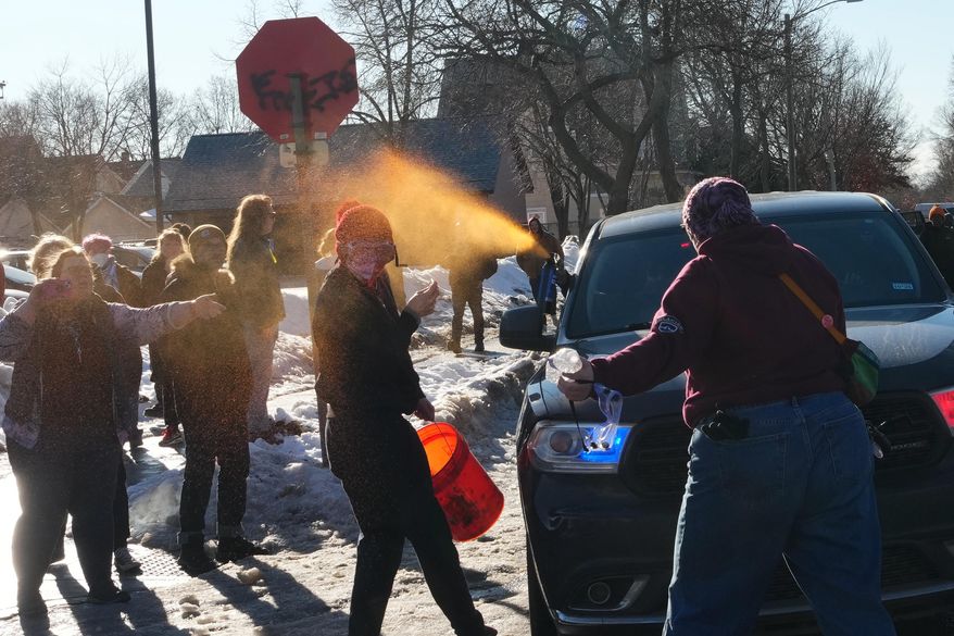 A protester is sprayed with pepper spray by a Federal agent Tuesday, Jan. 13, 2026, in Minneapolis.(AP Photo/Adam Gray)