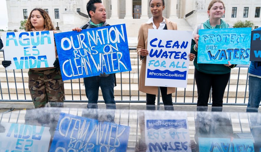 Bethsaida Sigaran, left, of Baltimore, her brother Jaime Sigaran, with American Rivers, and Thea Louis, with Clean Water Action, join other supporters of the Clean Water Act as they demonstrate outside the Supreme Court, Oct. 3, 2022, in Washington, as the court begins arguments in Sackett v. Environmental Protection Agency (EPA). (AP Photo/Jacquelyn Martin, File)