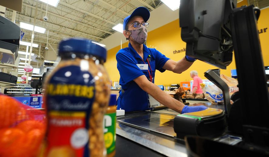 A cashier rings up groceries in Dallas, Aug. 28, 2025. (AP Photo/LM Otero, File)